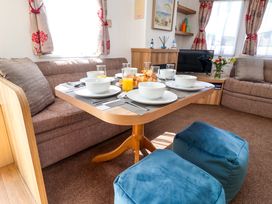 A dining area with a table set for breakfast at 21 Poplar Avenue in Felixstowe, Suffolk