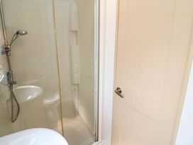 A shower and sink in a bathroom at 21 Poplar Avenue, Felixstowe, Suffolk