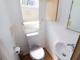 A bathroom featuring a toilet and sink at 21 Poplar Avenue in Felixstowe, Suffolk