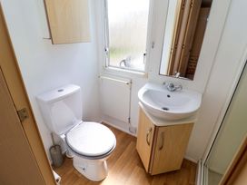 A bathroom with a toilet and sink at 21 Poplar Avenue in Felixstowe, Suffolk