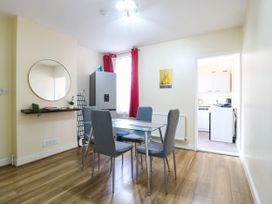 A dining room with a table and chairs at Dover Retreat