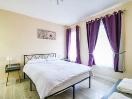 A bedroom with a bed and nightstand at Dover Retreat