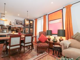 A dining room with a table and chairs at Bohemian Beach Cottage in Bournemouth