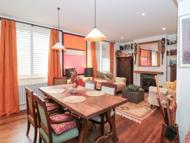 A dining room with a table and chairs at Bohemian Beach Cottage in Bournemouth