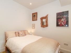 A bedroom with a bed and wall decorations at Bohemian Beach Cottage in Bournemouth