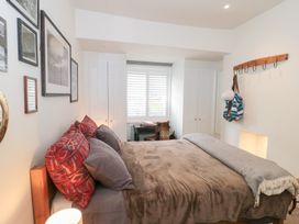 A bedroom with a bed and desk at Bohemian Beach Cottage in Bournemouth