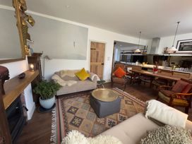 A living room with a sofa and coffee table at Bohemian Beach Cottage in Bournemouth
