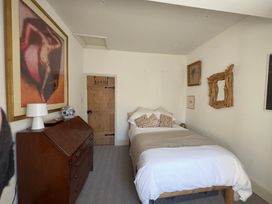 A bedroom with a bed and furniture at Bohemian Beach Cottage in Bournemouth