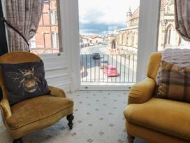 A living room with a view of the street and church at Stanton House - Abbey View, Flat 3 