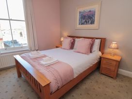 A bedroom with a bed and bedside tables at Stanton House - Abbey View, Flat 3