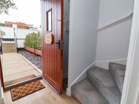 An entrance with a wooden door and stairs at Butterfly Days in Bideford