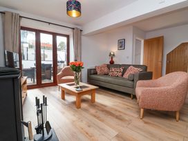 A living room with a sofa and coffee table at Butterfly Days in Bideford