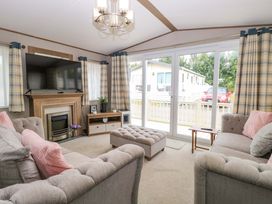 A living room with a television and sofa at 17 Castle Walk in Great Yarmouth