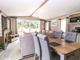 A living room with a dining area and television at 17 Castle Walk in Great Yarmouth