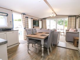 A living room with a dining table and sofa at 17 Castle Walk in Great Yarmouth