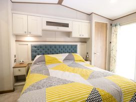 A bedroom with a bed and bedside table at 17 Castle Walk in Great Yarmouth