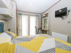 A bedroom with a bed and desk at 17 Castle Walk in Great Yarmouth