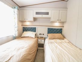 A bedroom with two beds and cabinets at 17 Castle Walk in Great Yarmouth