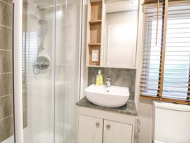 A bathroom with a shower and sink at 17 Castle Walk in Great Yarmouth