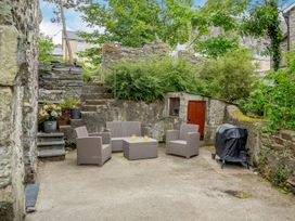 An outdoor seating area with furniture and a barbecue grill at Brondderwen