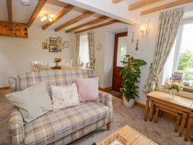 A living room with a sofa and table at Brondderwen in Blaenau Ffestiniog