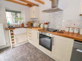 A kitchen with a sink and oven at Brondderwen in Blaenau Ffestiniog