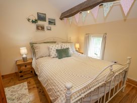 A bedroom with a bed and a nightstand at Brondderwen in Blaenau Ffestiniog