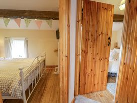 A bedroom with a bed and a door at Brondderwen in Blaenau Ffestiniog