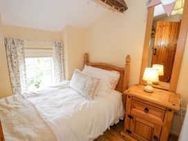 A bedroom with a bed and bedside table at Brondderwen in Blaenau Ffestiniog