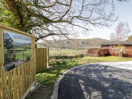 A view of Alpine Lodges with a wooden sign at Summertime Lodge Rhyd-y-Foel near Abergele