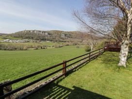 A landscape view with a fence and trees at Alpine Lodge Rhyd-y-Foel near Abergele