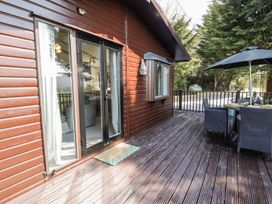 An outdoor space with a table and chairs at Springtime Lodge in Rhyd-y-Foel near Abergele