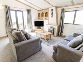 A living room with a sofa and coffee table at Springtime Lodge Rhyd-y-Foel near Abergele