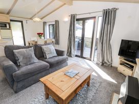 A living room with a sofa and coffee table at Springtime Lodge Rhyd-y-Foel near Abergele