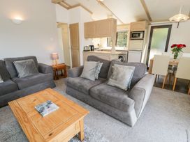 A living room with a sofa and coffee table at Springtime Lodge in Rhyd-y-Foel near Abergele