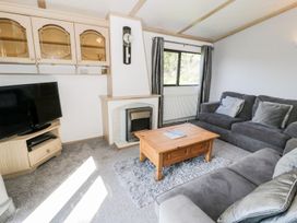 A living room with a sofa and coffee table at Springtime Lodge in Rhyd-y-Foel near Abergele