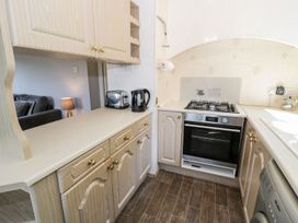 A kitchen with cupboards and appliances at Springtime Lodge in Rhyd-y-Foel near Abergele