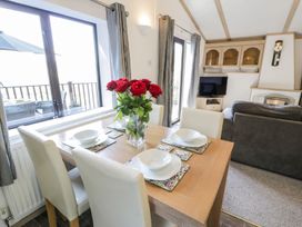A dining room with a table and chairs at Springtime Lodge Rhyd-y-Foel near Abergele