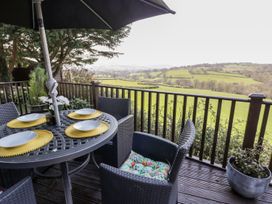 An outdoor seating area with a table and chairs at Springtime Lodge in Rhyd-y-Foel near Abergele