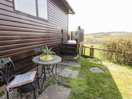 An outdoor area with a table and chairs at Springtime Lodge in Rhyd-y-Foel near Abergele