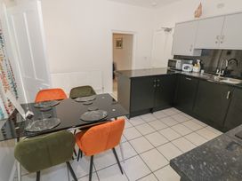 A kitchen with a dining table and chairs at Raglan Lodge in Monmouth