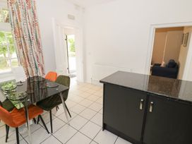 A dining room with a table and chairs at Raglan Lodge Monmouth