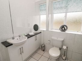 A bathroom with a sink and toilet at Raglan Lodge in Monmouth