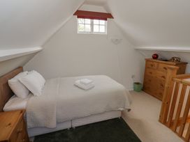A bedroom with a bed and a dresser at Raglan Lodge in Monmouth