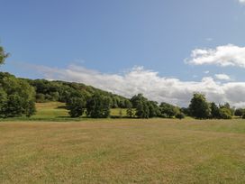 A landscape with trees and grass at Raglan Lodge Monmouth