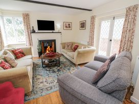 A living room with a sofa and a fireplace at Hillside Cottage