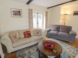 A living room with a sofa and coffee table at Hillside Cottage