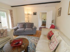 A living room with sofas and a coffee table at Hillside Cottage 