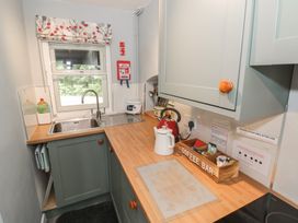 A kitchen with a sink kettle and coffee bar at Hillside Cottage