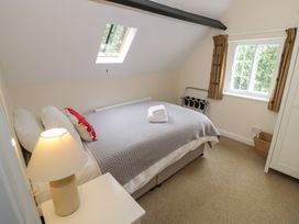 A bedroom with a bed and lamp at Hillside Cottage 